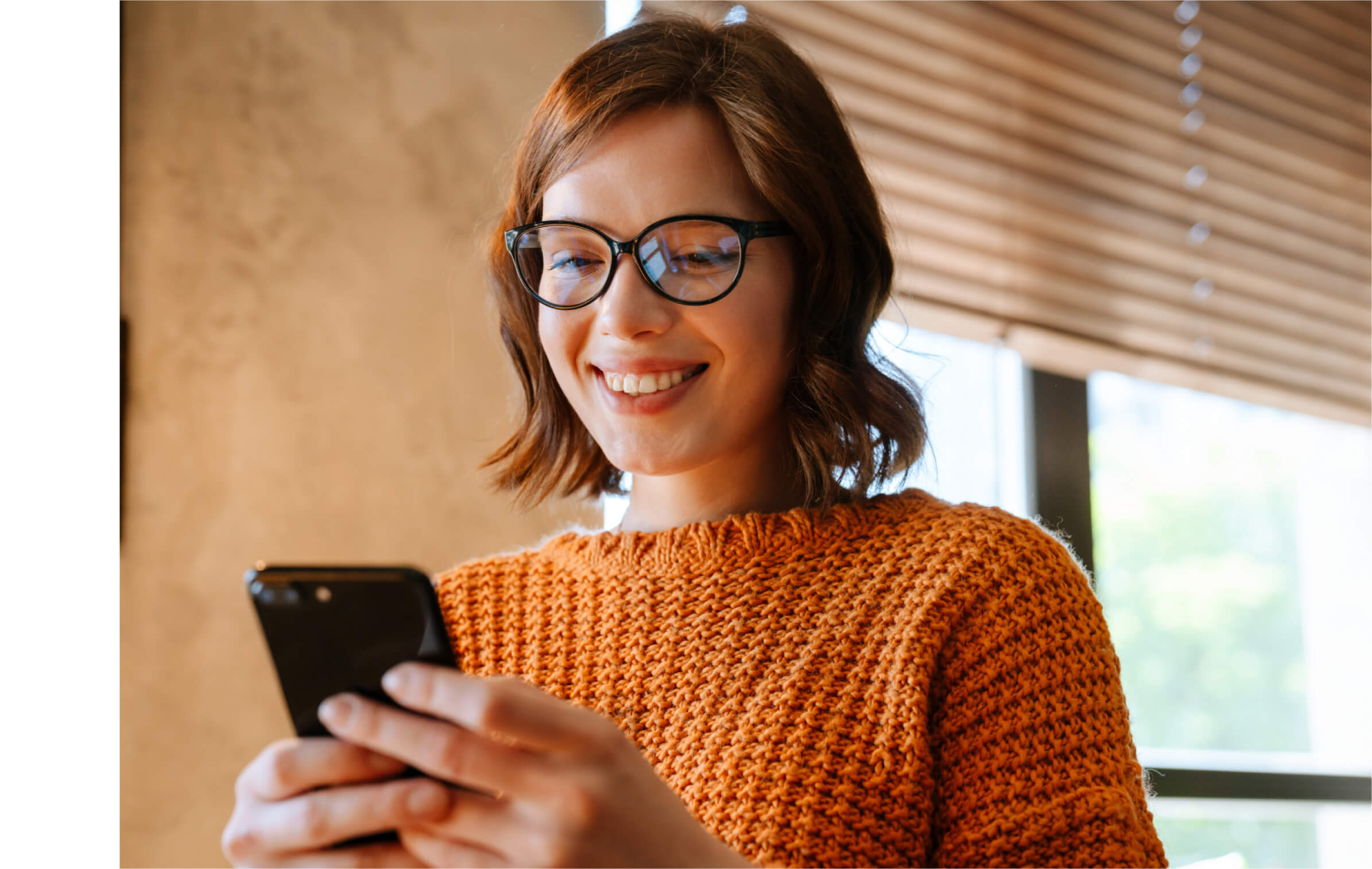 A closeup of a woman looking at her phone. 